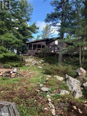 The Archipelago (Archipelago South) house for rent - A small wooden cabin is nestled among the trees in a forested area.