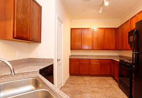 Newport apartment for rent - a kitchen with granite counter tops and wooden cabinets
