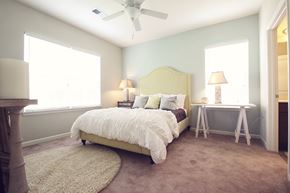 Greenville apartment for rent - a bedroom with a bed and a ceiling fan