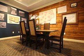 Greenville apartment for rent - a dining room table with chairs and maps on the wall
