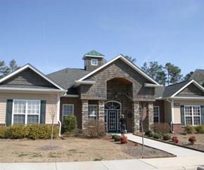 Greenville condo for rent - A house with a green roof and a brick facade.