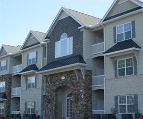 Greenville condo for rent - A row of houses with balconies and stone pillars.