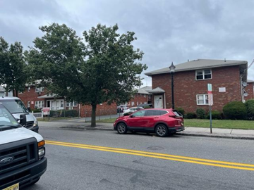 Hackensack apartment for rent - A red car is parked on the side of a street.