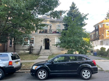 Ridgefield Park apartment for rent - A black car is parked on the street in front of a house.