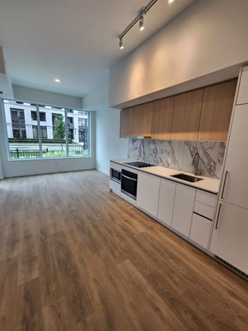 Toronto apartment for rent - A kitchen with white cabinets and a marble countertop.