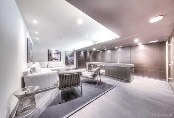 Toronto apartment for rent - A modern living room with a white sofa and a grey chair.