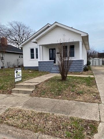 Owensboro house for rent - A small white house with a grey front yard.