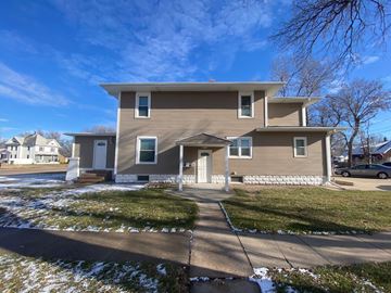 Kearney apartment for rent - A house with a grey facade stands in a residential area.