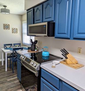 Loudon house for rent - A kitchen with blue cabinets and a black stove top.