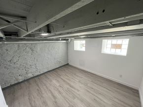St. Louis house for rent - A room with wooden flooring and a stone wall.