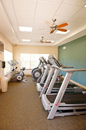 Orange apartment for rent - A row of treadmills in a gym.