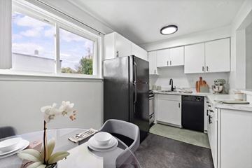 Royal Oak apartment for rent - A kitchen with a table and chairs in front of it.