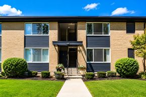 Royal Oak apartment for rent - A building with a front yard and a walkway leading to the entrance.