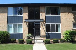 Royal Oak apartment for rent - A brick building with a black door and windows.