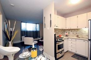 Ottawa apartment for rent - A kitchen with a table set for two with orange juice and two glasses.