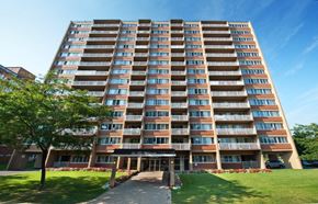 Cote St Luc apartment for rent - A large apartment building with a grassy area in front.