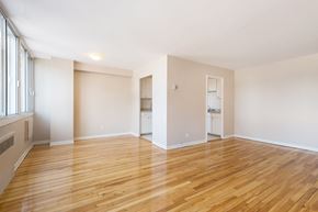 Cote St Luc apartment for rent - A room with wooden floors and white walls.