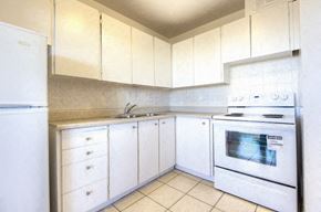 Toronto apartment for rent - A kitchen with white appliances and cabinets.