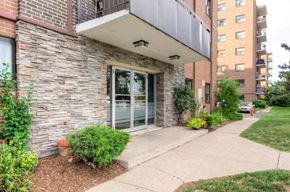 Mississauga apartment for rent - A building with a stone facade and a glass door.