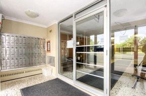 Mississauga apartment for rent - A glass door with a black mat in front of it.