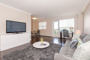 Burlington apartment for rent - A living room with a grey couch and a flat screen TV.