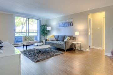 London apartment for rent - A living room with a grey couch and a white coffee table.