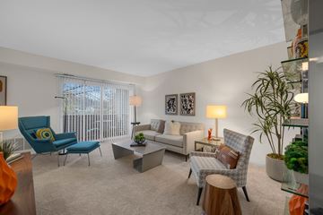 Farmington Hills apartment for rent - A living room with a blue chair and a grey couch.