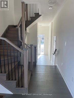 Newmarket (Woodland Hill) house for rent - A hallway with a staircase and a door at the end.