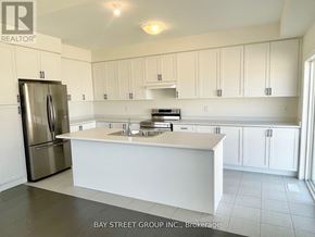 Newmarket (Woodland Hill) house for rent - A kitchen with white cabinets and a stainless steel refrigerator.