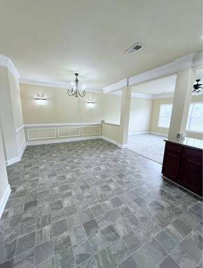 Chambersburg apartment for rent - A spacious room with a checkered tile floor and a chandelier.