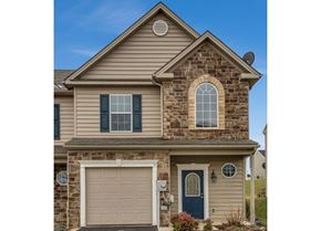 Chambersburg apartment for rent - A house with a blue door and a garage door.