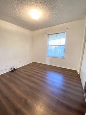 Lafayette house for rent - A room with a window and wooden flooring.