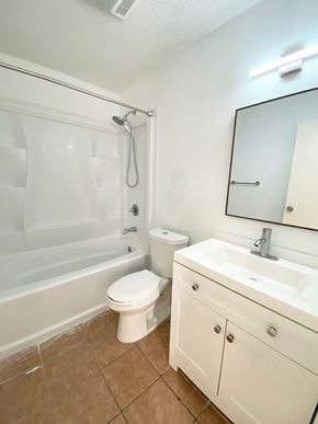 Lafayette house for rent - A white bathroom with a toilet, sink, and bathtub.