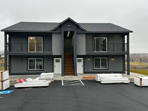Benton City apartment for rent - A grey two story house with a balcony on the second floor.