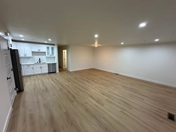 Benton City apartment for rent - A kitchen with white cabinets and a wooden floor.