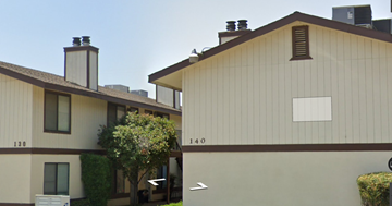 Exeter apartment for rent - A building with a brown roof and a white sign that says 130.
