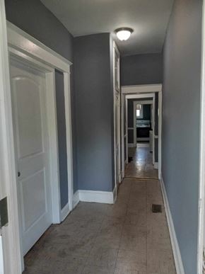 Baltimore apartment for rent - A long hallway with doors on both sides.