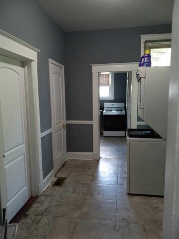 Baltimore apartment for rent - A kitchen with a white refrigerator and a white door.