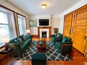 Denver apartment for rent - A living room with a fireplace and a television.