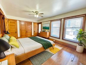 Denver apartment for rent - A large building with a green awning and a black fence in front.