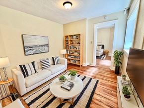 Denver apartment for rent - A building with a green awning and a white door.