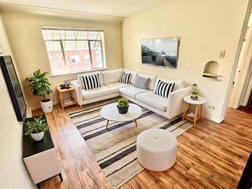 Denver apartment for rent - A red brick building with a green lawn in front.