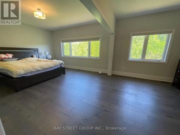 Aurora (Aurora Estates) house for rent - A bedroom with a large bed and two windows.