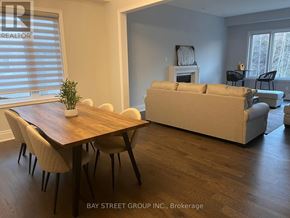 Aurora (Aurora Estates) house for rent - A living room with a couch, chairs, and a table.