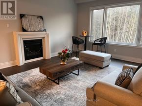 Aurora (Aurora Estates) house for rent - A living room with a fireplace and a couch.
