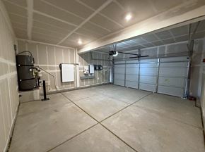 Merced house for rent - A spacious garage with a concrete floor and white walls.