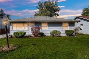 Gary house for rent - A house with a grey roof and a green lawn in front.