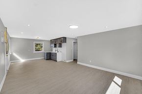 Gary house for rent - A spacious room with a cabinet and a window.