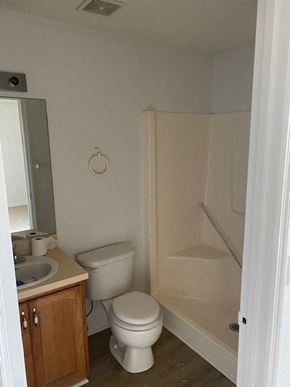 Homosassa house for rent - A bathroom with a toilet, sink, and shower.