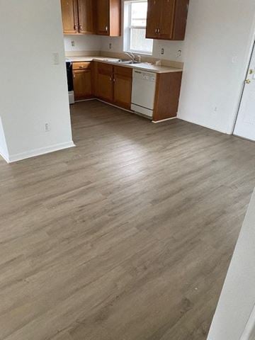 Homosassa house for rent - A kitchen with wooden cabinets and a white dishwasher.